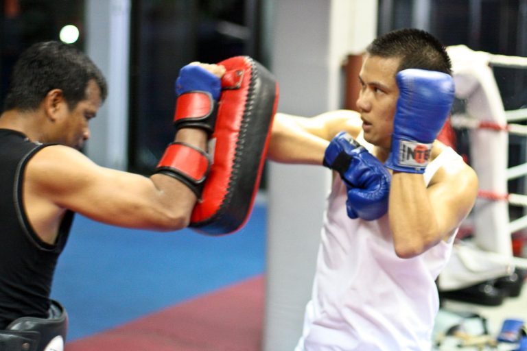 Teacher and student practicing Muay Thai at Chacrit Muay Thai School in Bangkok