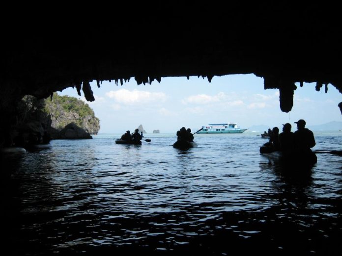Canoe in Ao Phang Nga National Park beneath limestone cliffs