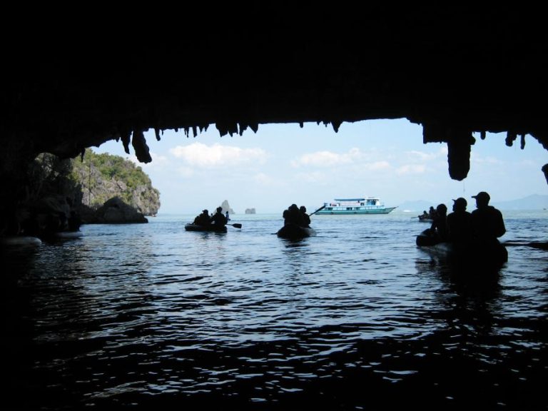 Canoe in Ao Phang Nga National Park beneath limestone cliffs