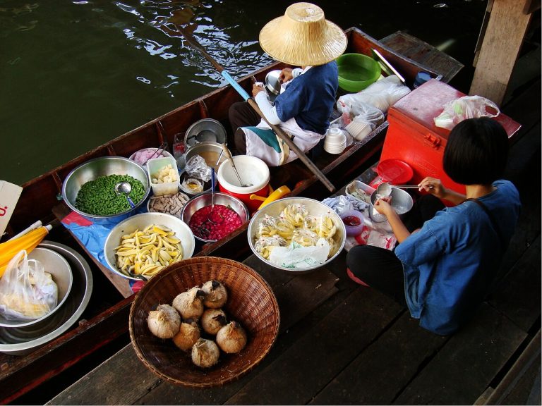 Food boats and seating at Taling Chan Floating Market in Bangkok