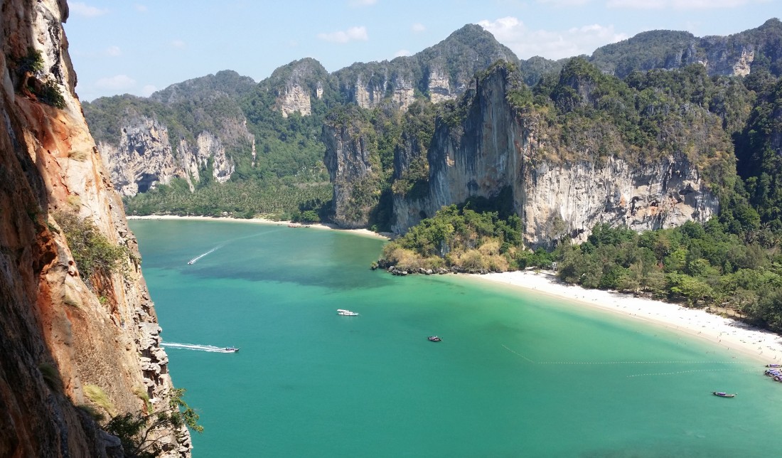 Guided climber ascending limestone at Railay in Krabi