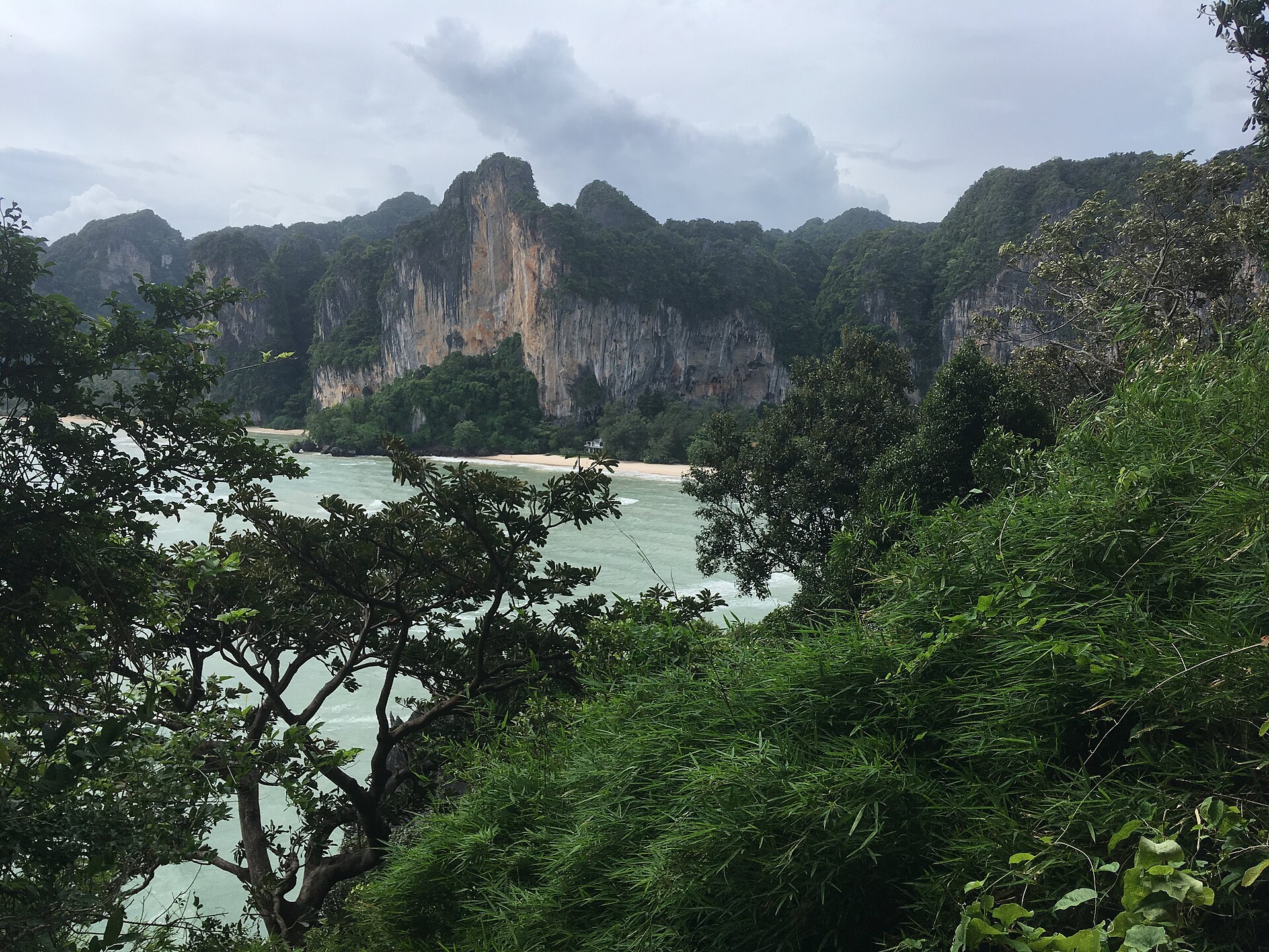 Boats and limestone cliffs at Rai Leh Bay in Krabi