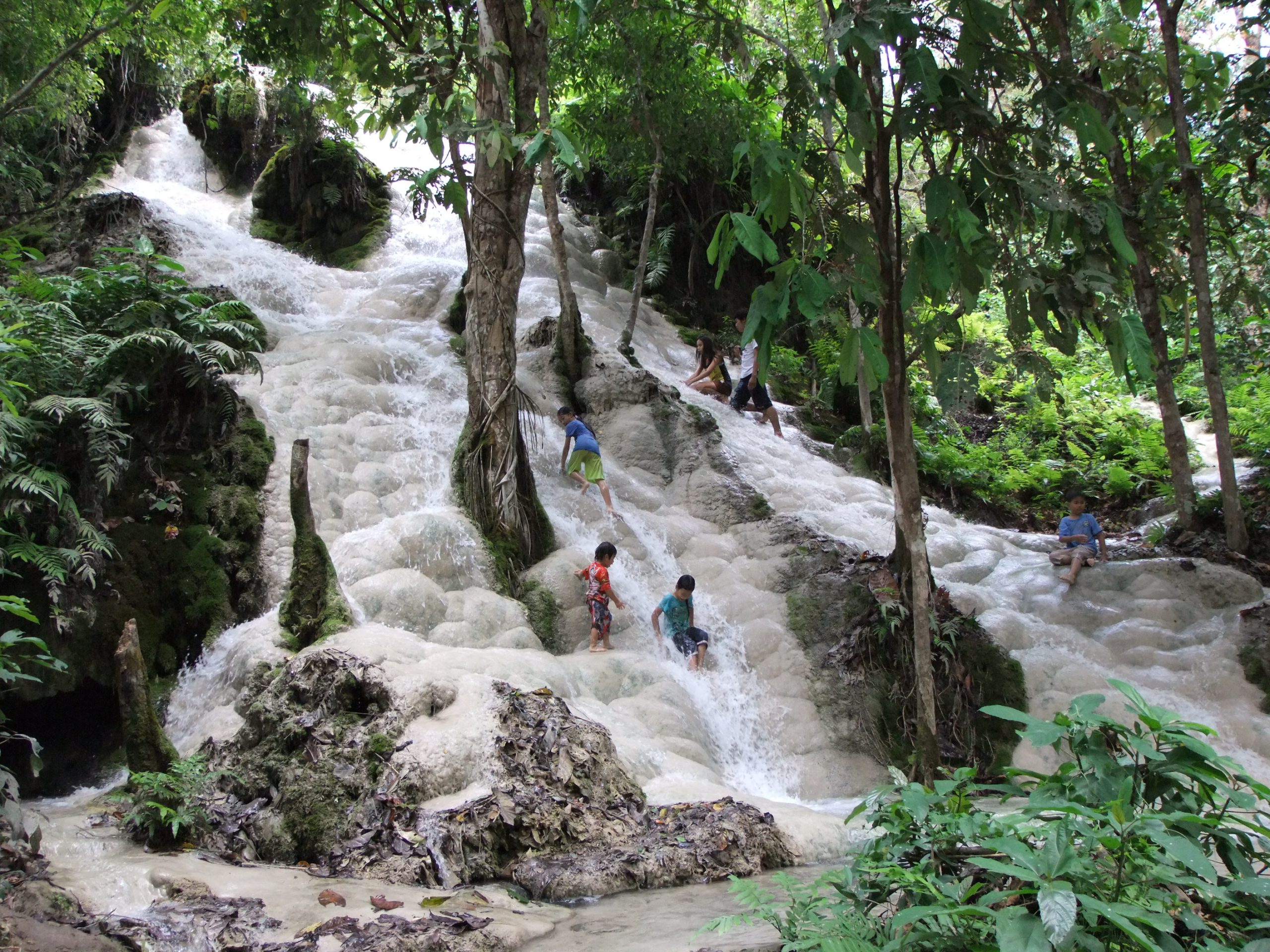 Visitors moving carefully on Bua Tong Waterfall