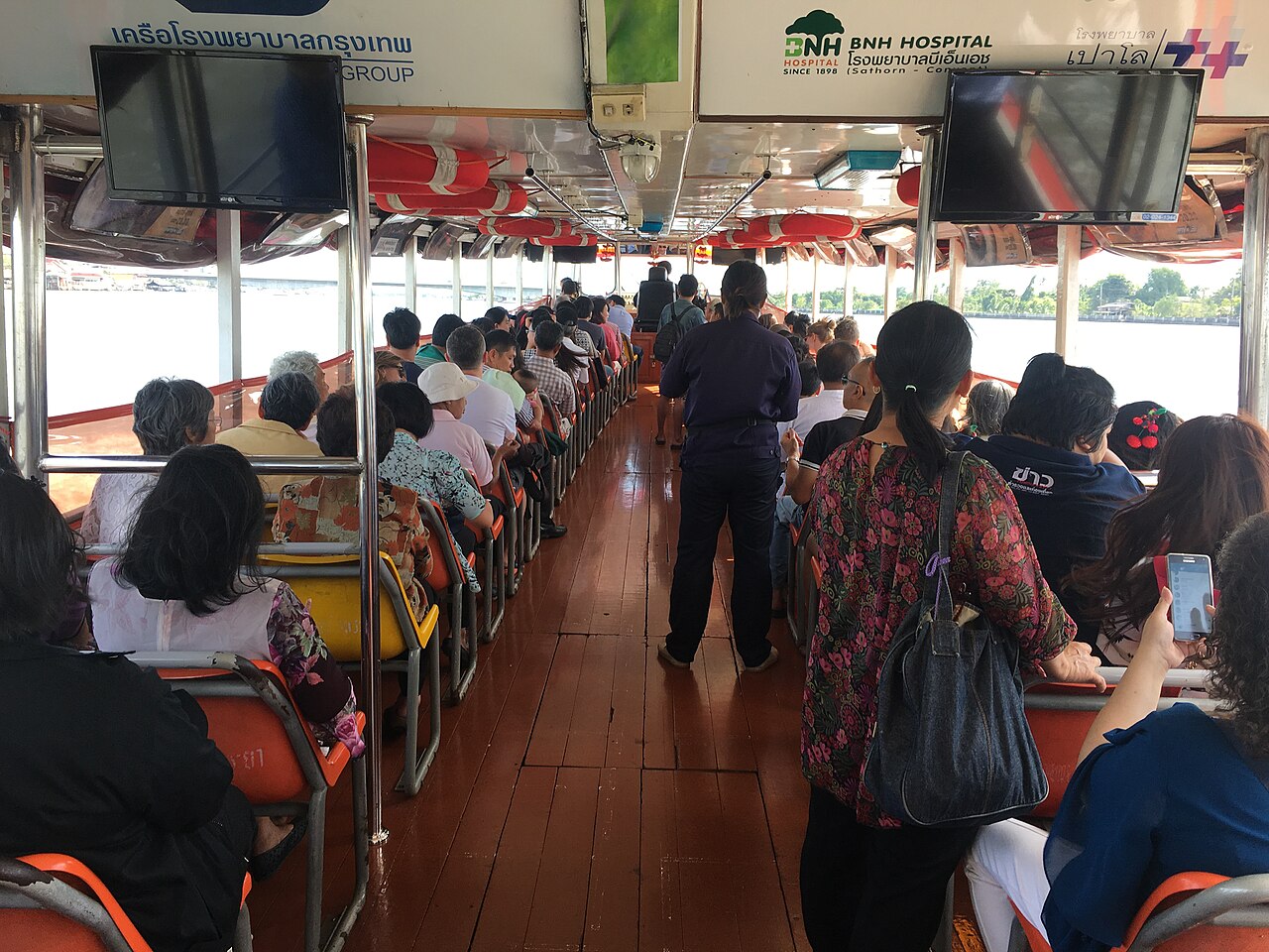 Orange-flag Chao Phraya Express Boat travelling through Bangkok