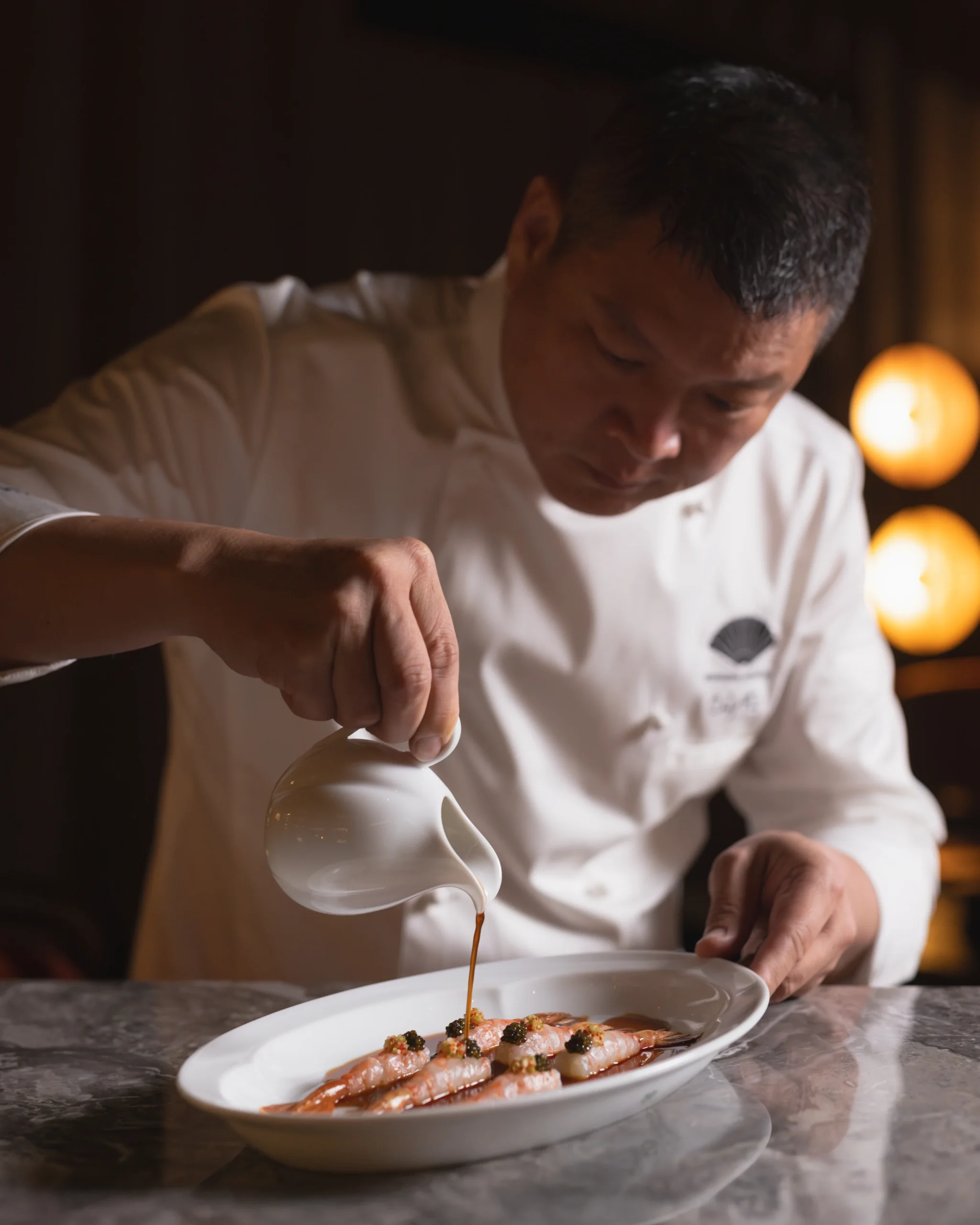 Chef Fei finishing langoustines at The China House Bangkok