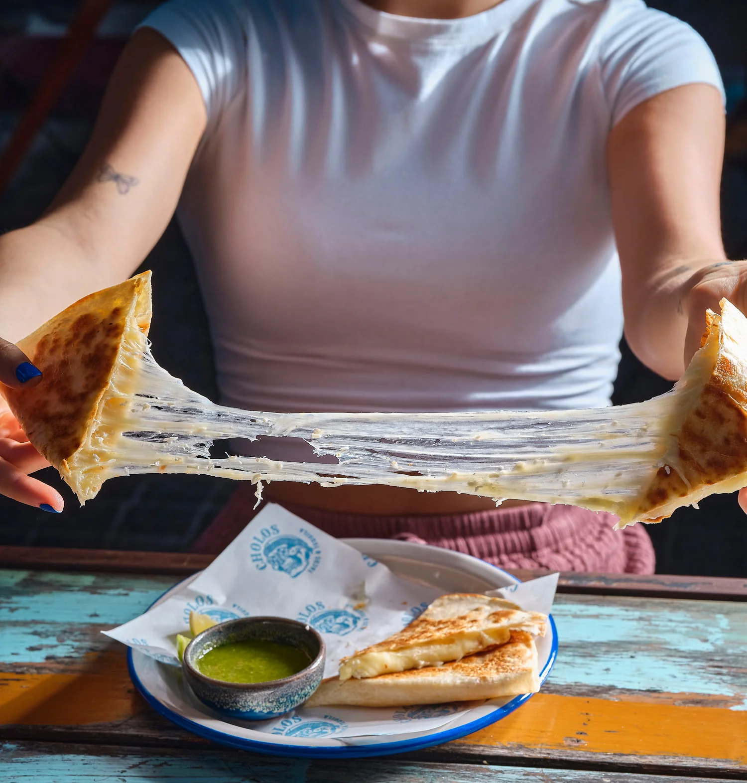 Cheese pull from a quesadilla served at Cholos