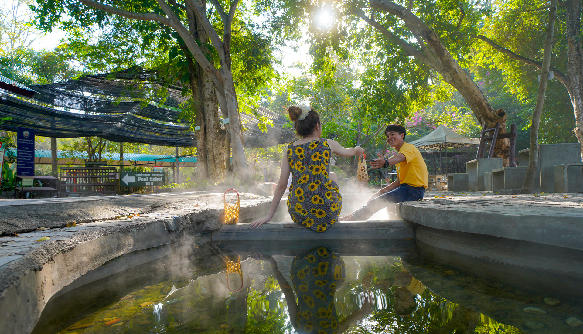 Visitors using a foot-soak channel at San Kamphaeng Hot Springs