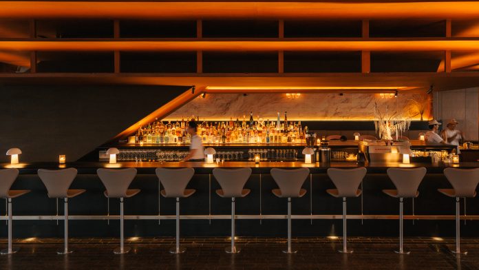 Warm wood interior and lounge seating at The Norm Bangkok