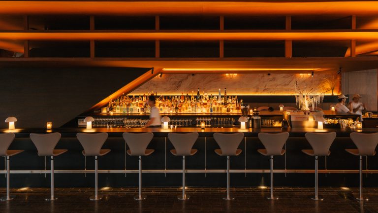 Warm wood interior and lounge seating at The Norm Bangkok