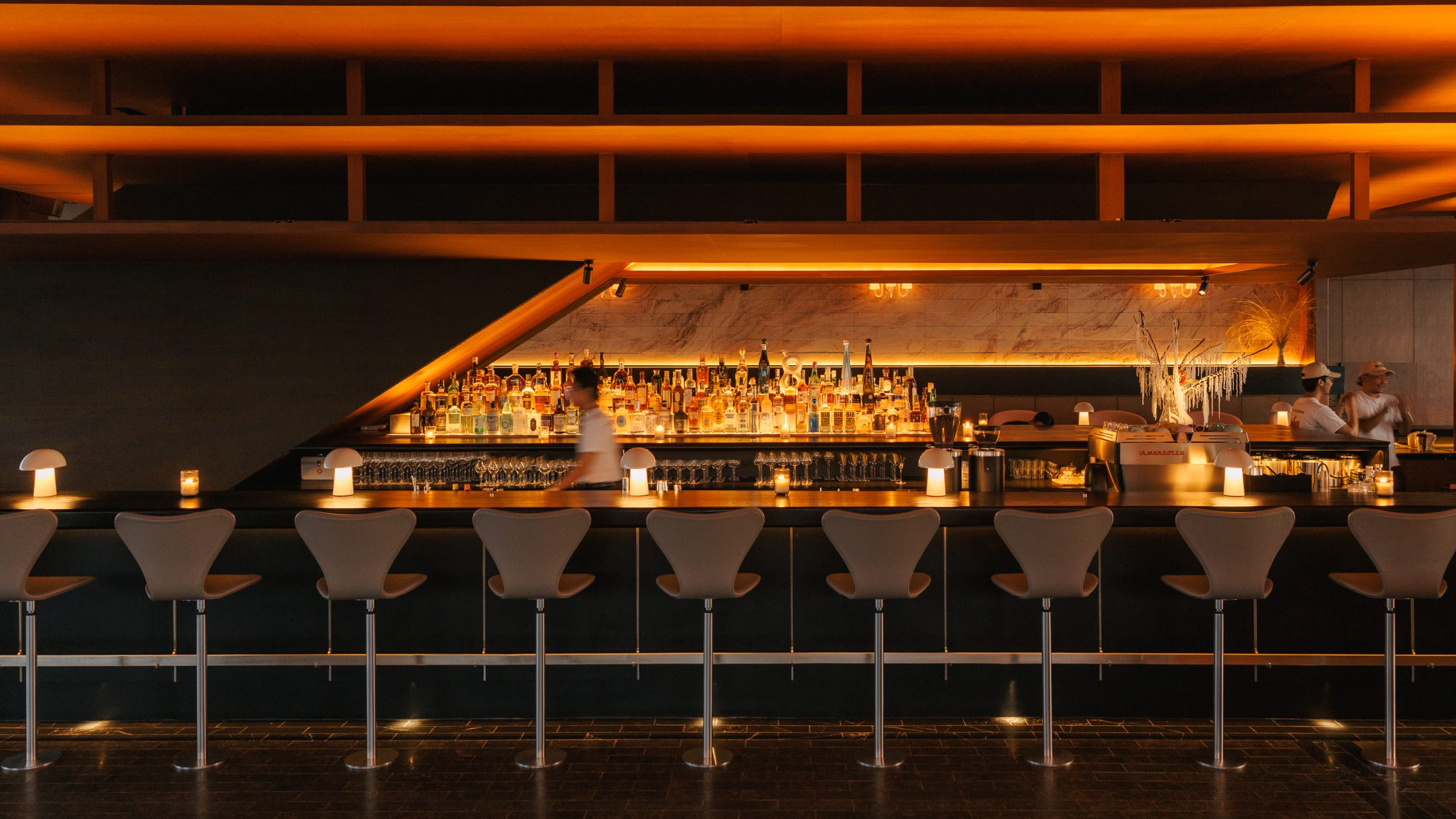 Warm wood interior and lounge seating at The Norm Bangkok