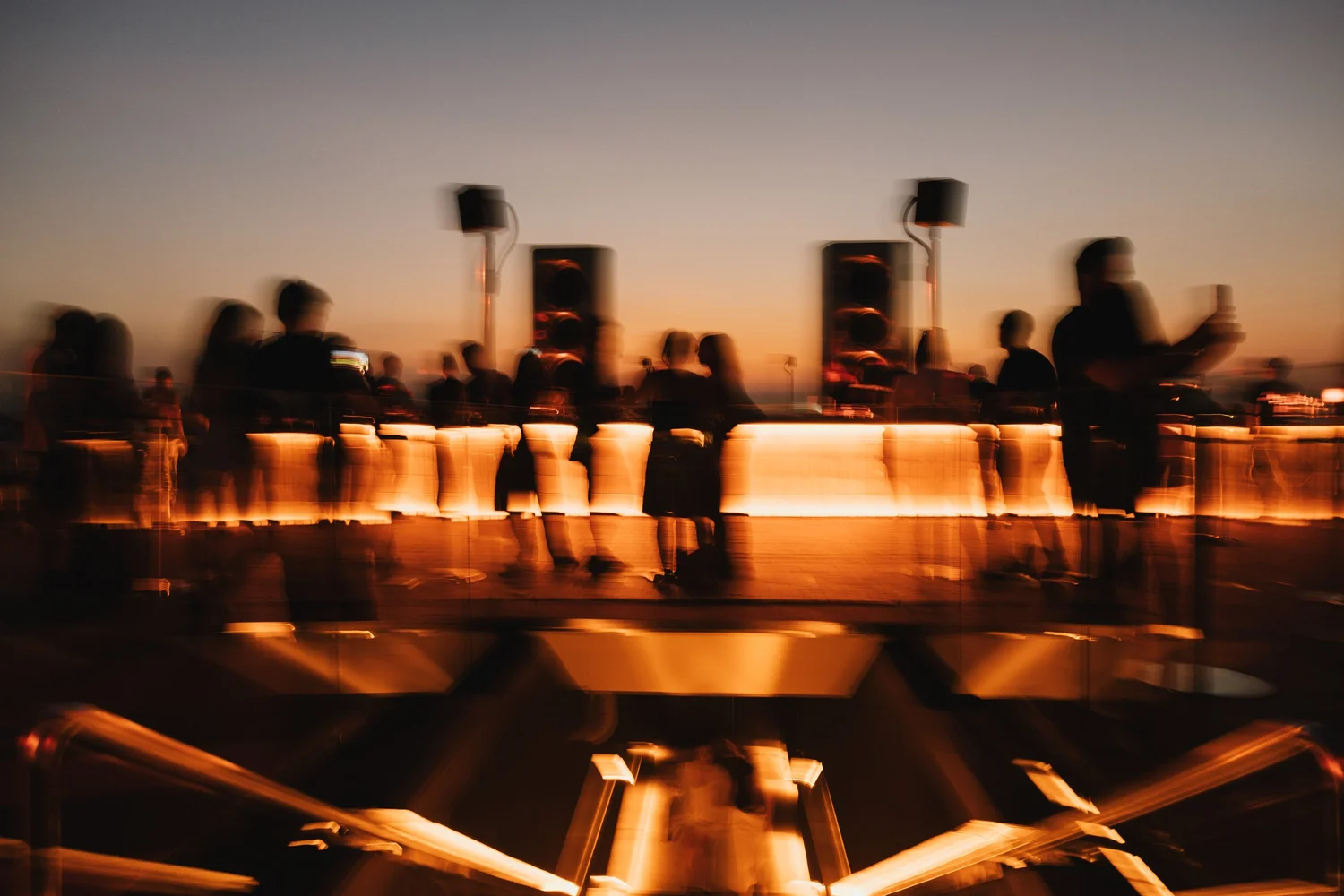 Guests at AETHER rooftop as Bangkok darkens