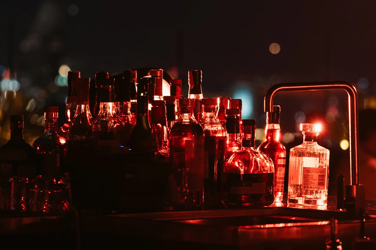 Bottles and bar lighting at AETHER Bangkok