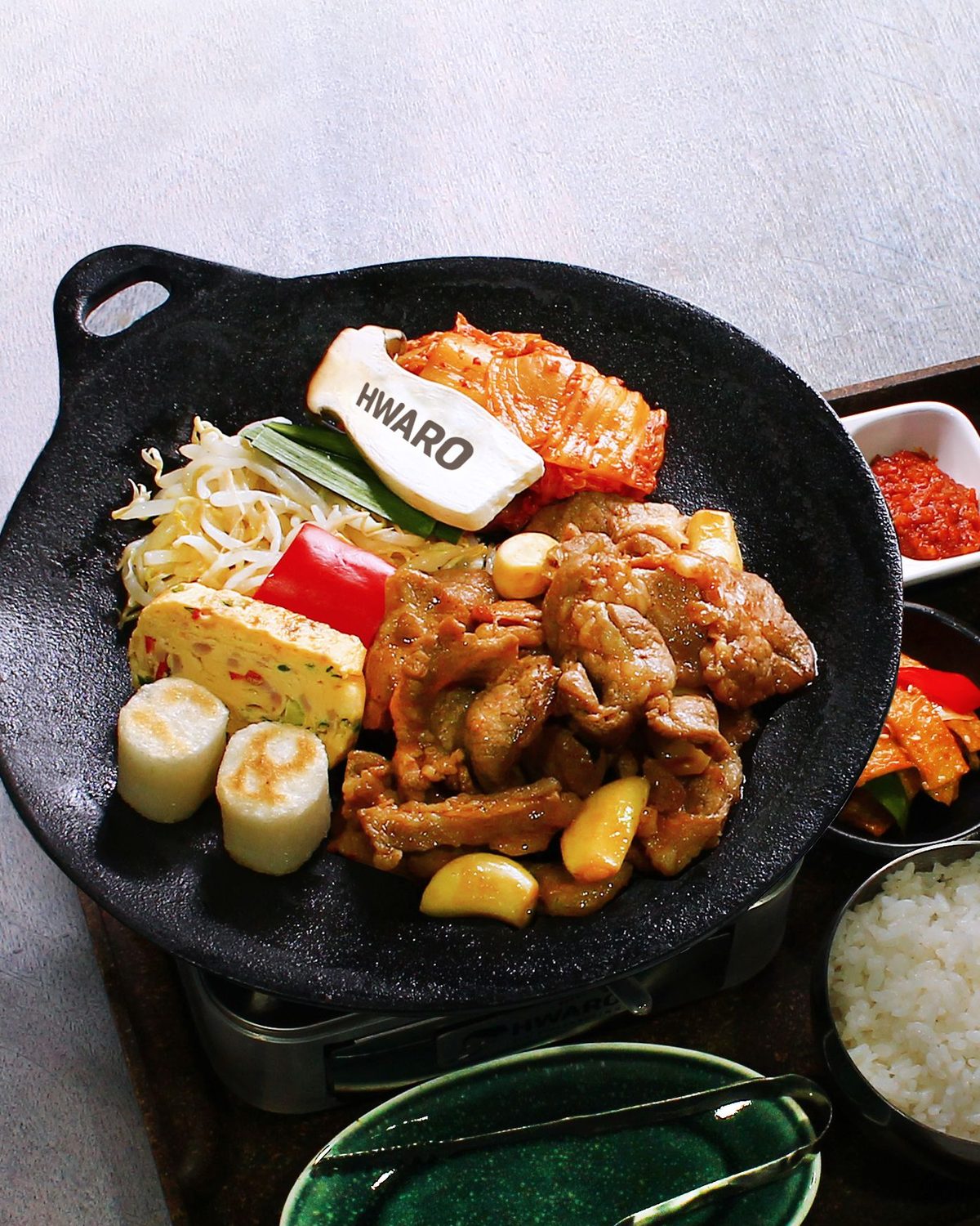 Korean pork bulgogi cooked on a griddle at Hwaro