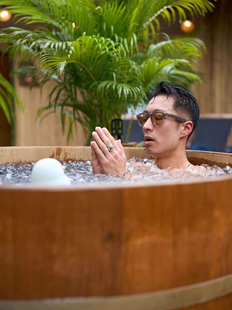 A guest using an ice bath at Rechill Asok