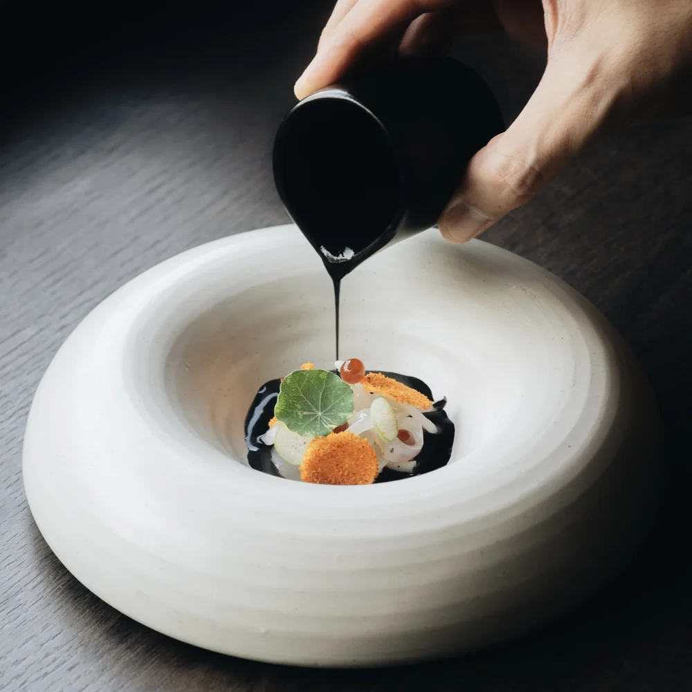 A sauce being finished tableside at Royd Phuket