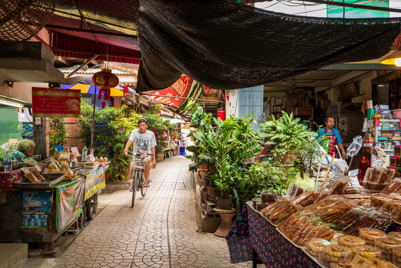 Narrow heritage lane lined with food stalls at San Chao Rong Thong Market