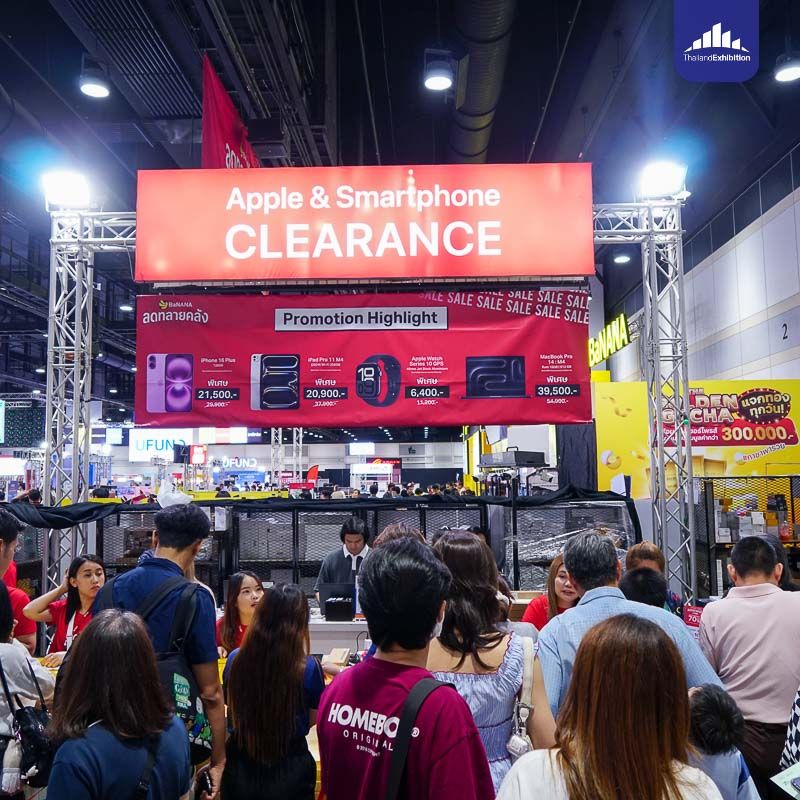 Visitors beneath a smartphone clearance sign at Thailand Mobile Expo 2026