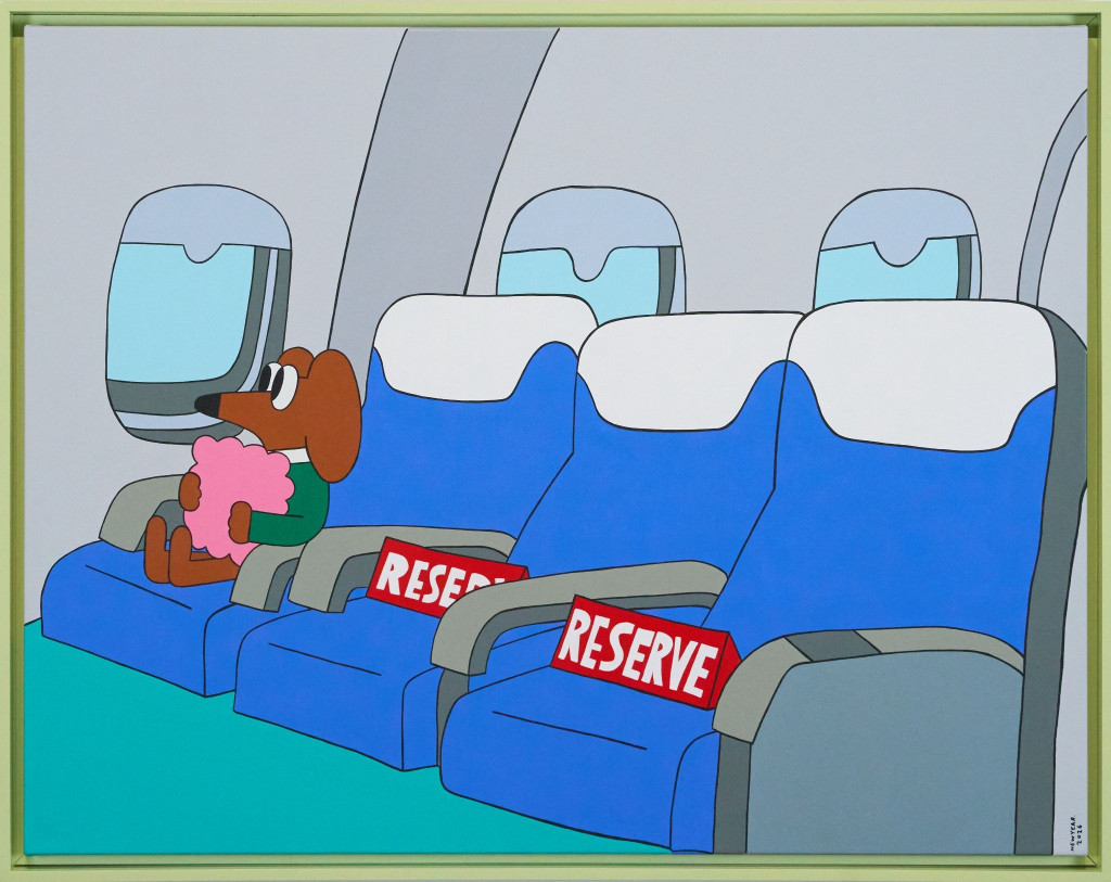Wednesday the dachshund seated alone on an aeroplane