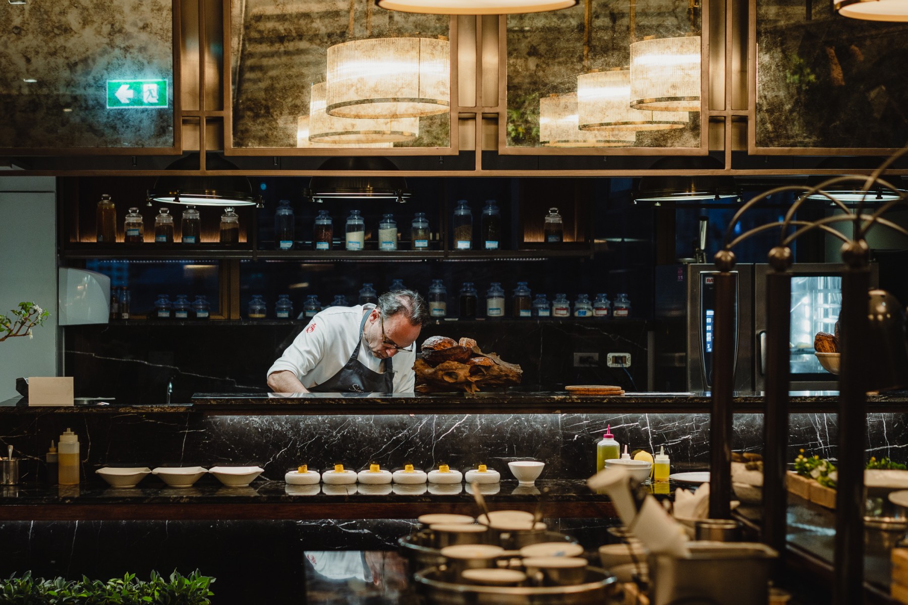 Chef working in the open kitchen at Signature Bangkok