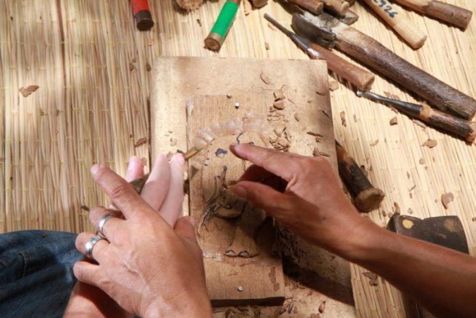 Baan Tawai woodcarving Artisan carving wood at Baan Tawai Craft Village