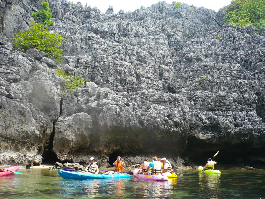 Kayakers beside limestone cliffs in Mu Ko Ang Thong