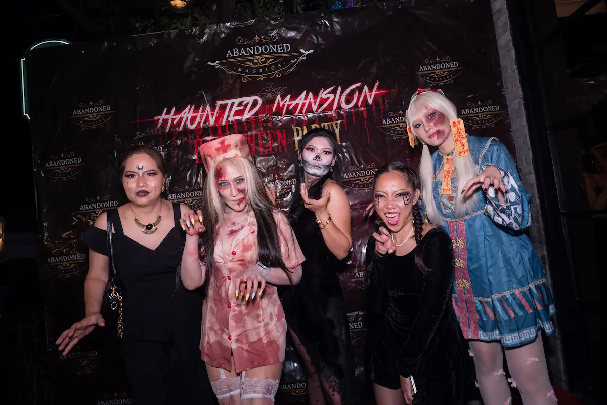 Guests posing by the Abandoned Mansion stage in Bangkok