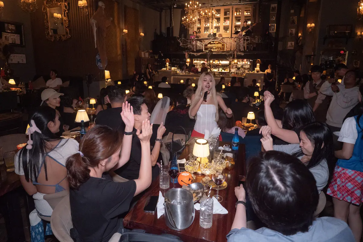 Lively audience and chandeliers at Abandoned Mansion Bangkok