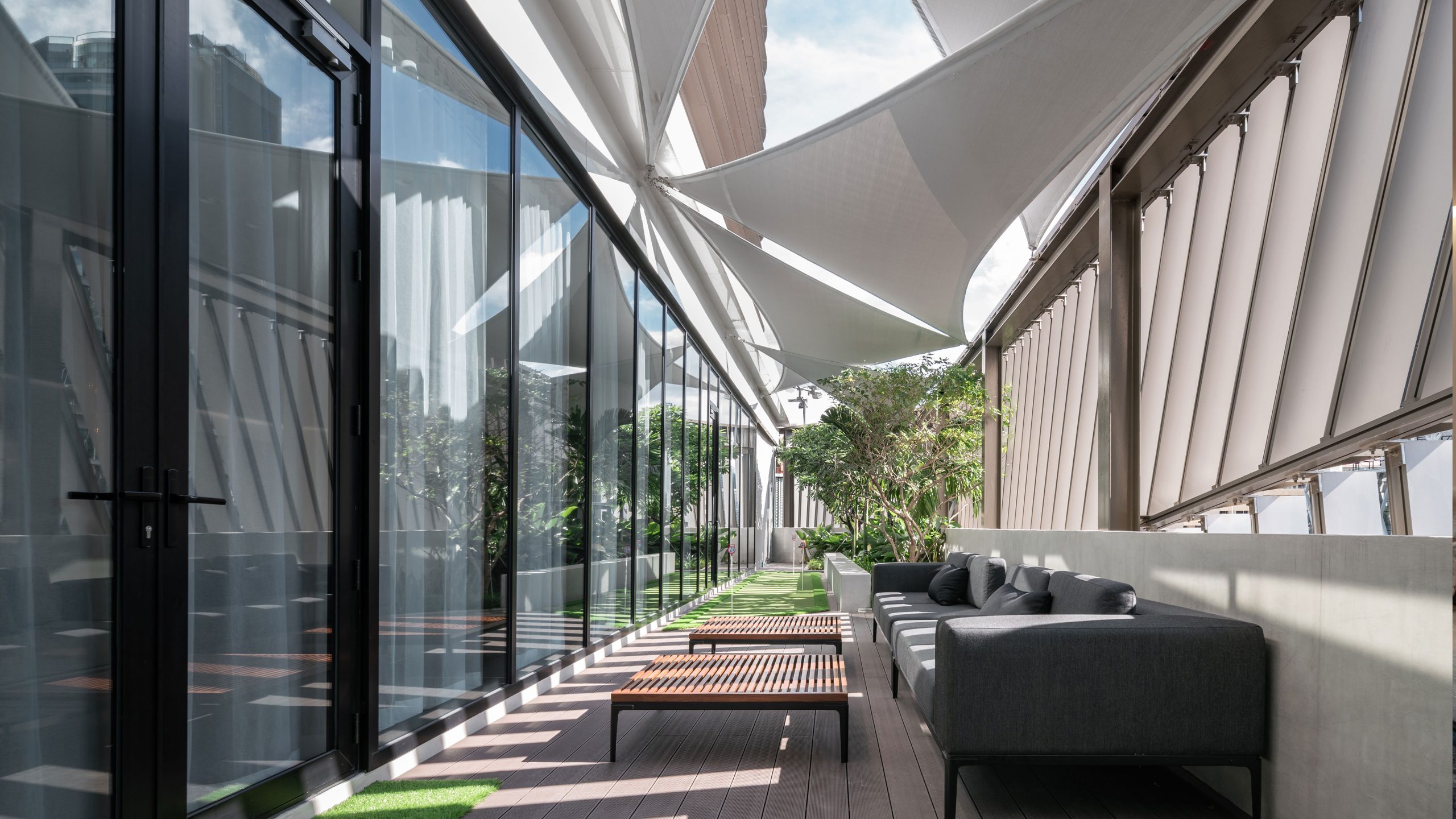 Covered terrace and greenery at AP House Bangkok