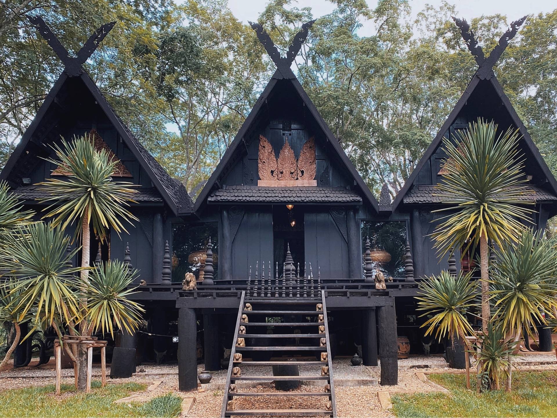 Three black wooden pavilions at Baan Dam Museum