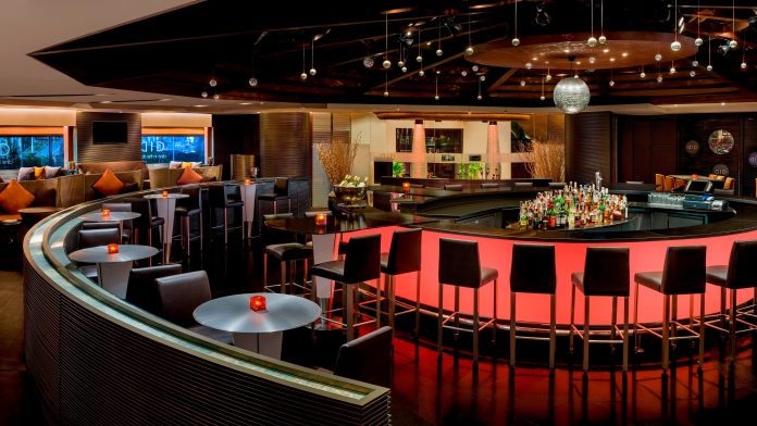 BARSU curved bar Curved illuminated bar and lounge seating inside BARSU Bangkok