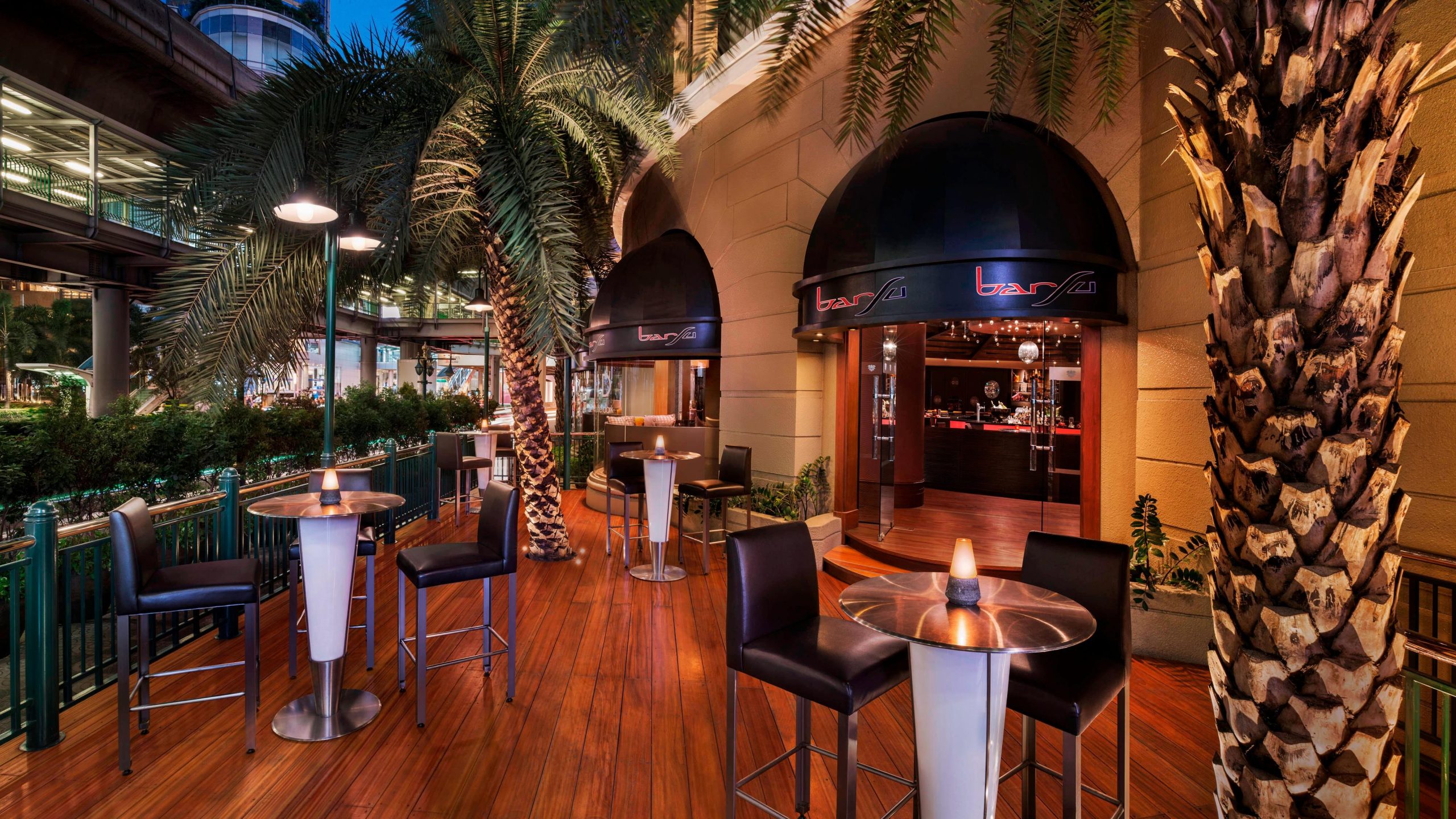 Outdoor terrace seating and palms at BARSU Bangkok