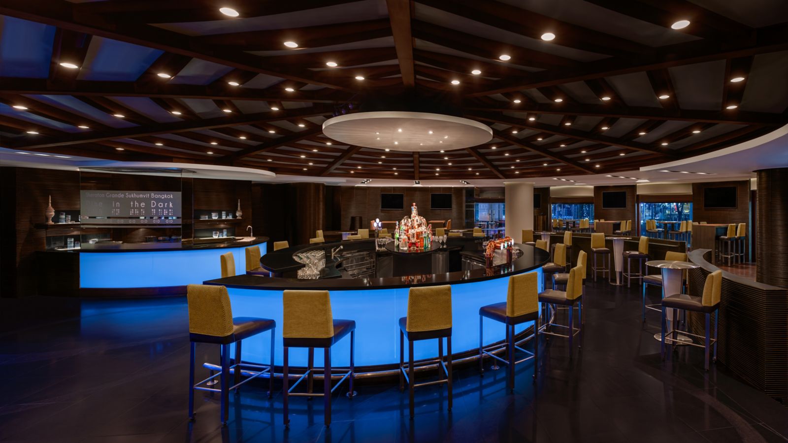 Blue-lit lounge and bar interior at BARSU Bangkok