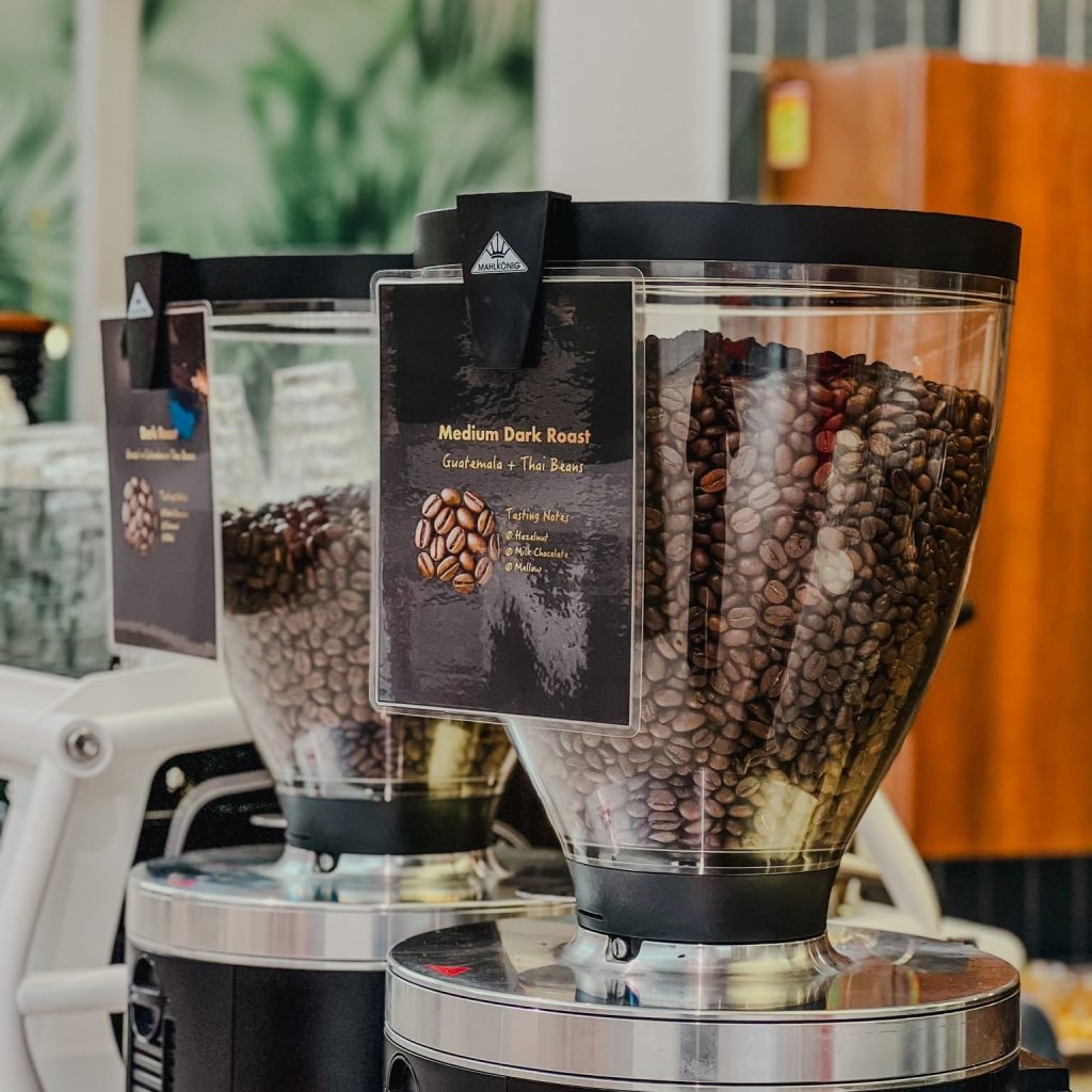 Coffee grinder and beans at Beva Coffee Roaster
