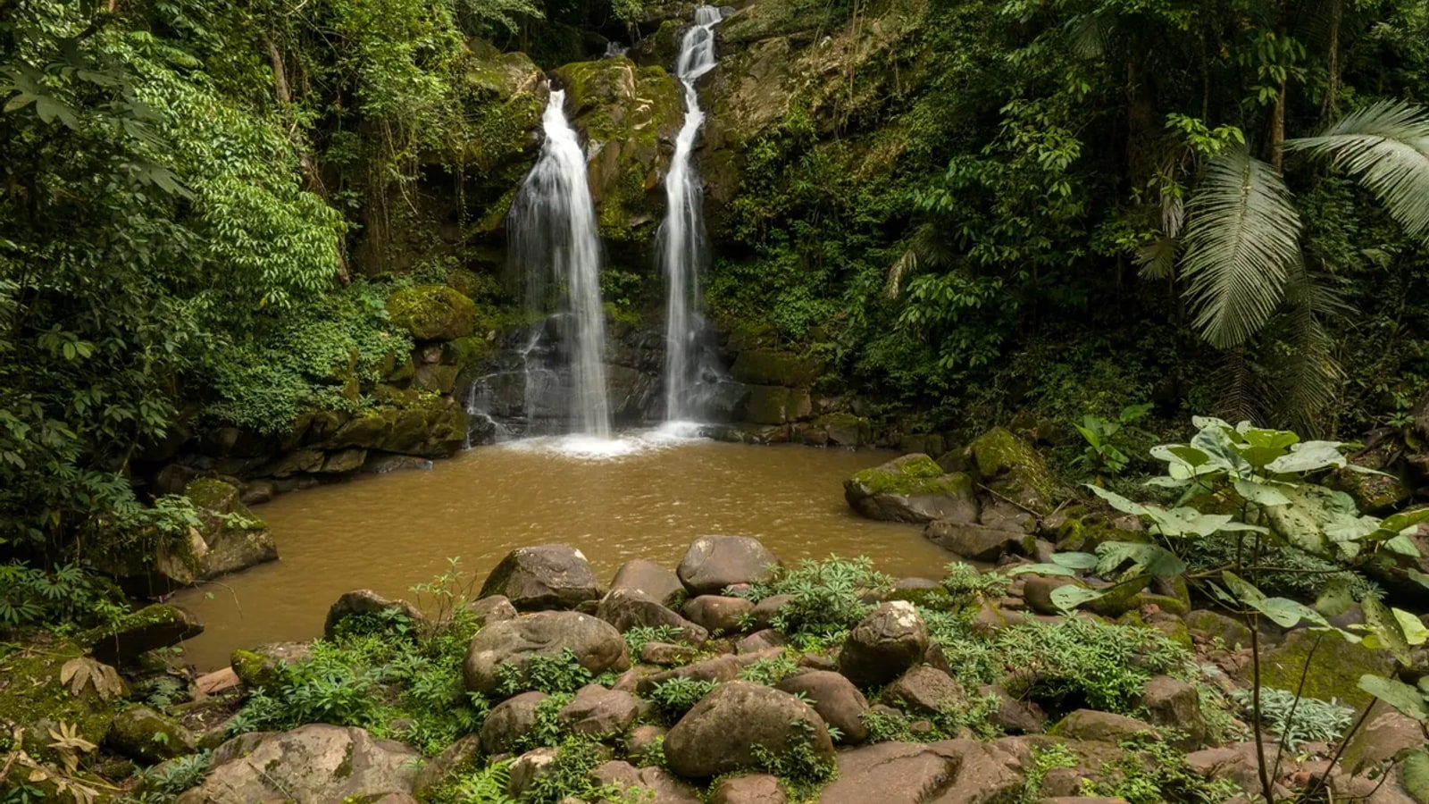 Three-tier Sapan Waterfall in green forest near Ban Sapan