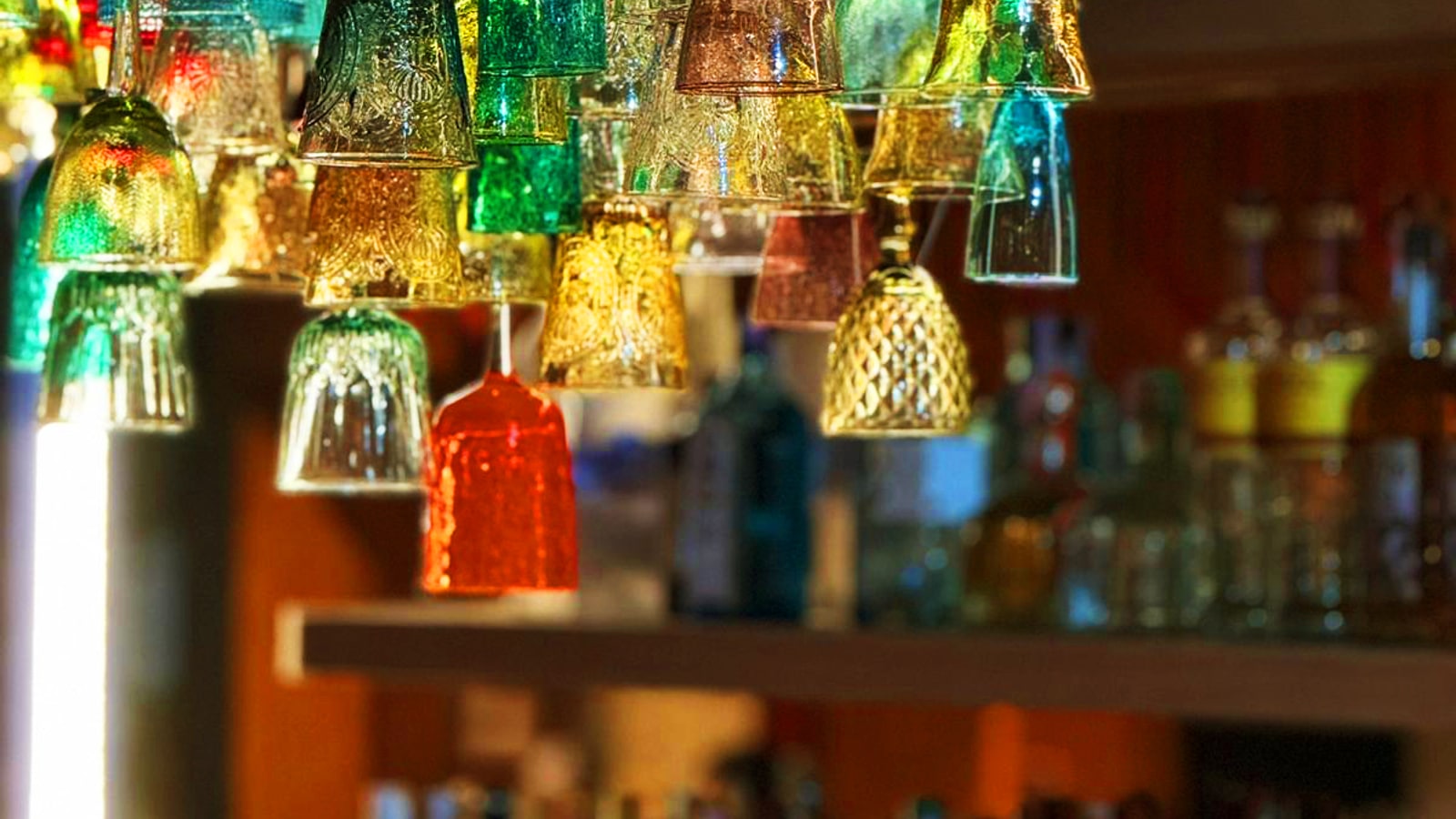 Colourful bottles and bar lighting inside Carmina Bangkok