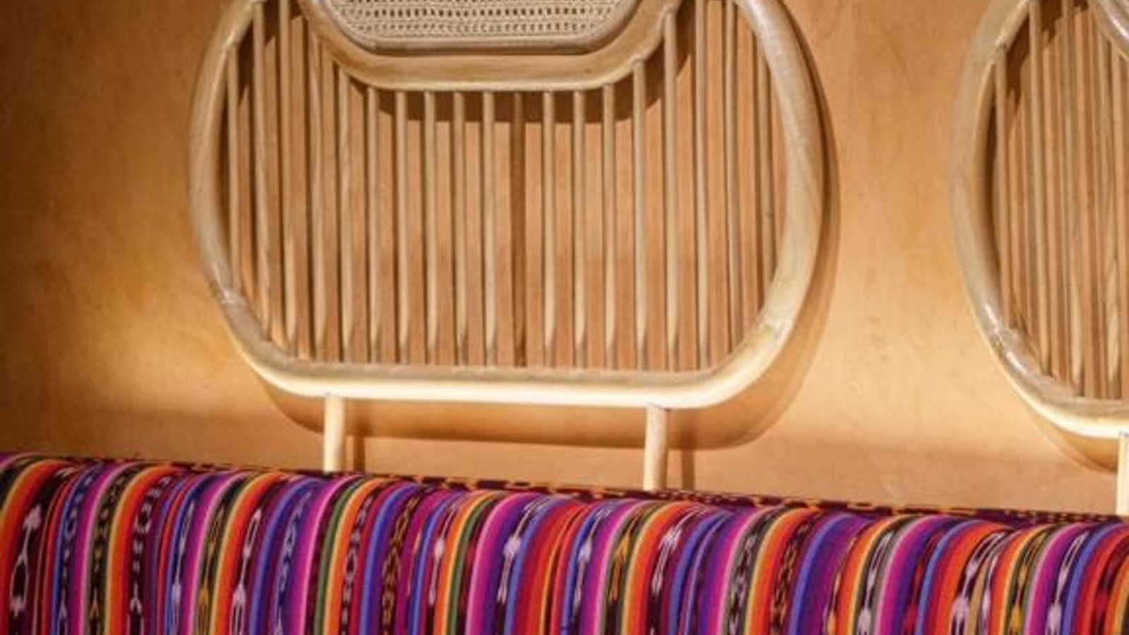 Woven chairs and colourful textiles inside Carmina Bangkok