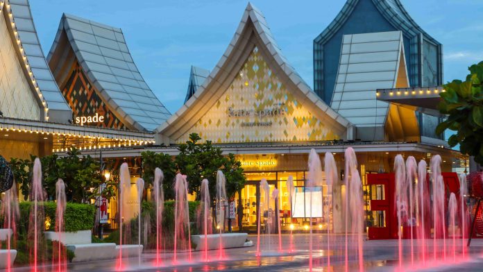 Central Village at dusk Central Village Bangkok Luxury Outlet storefronts and fountains at dusk
