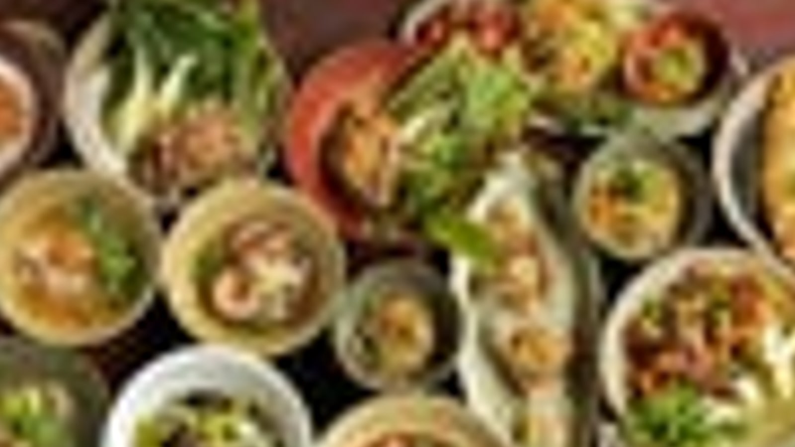 Overhead view of curries and side dishes from Charmgang Bangkok