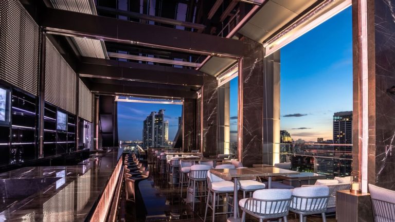 Open-air seating and skyline view at Cooling Tower Rooftop Bar