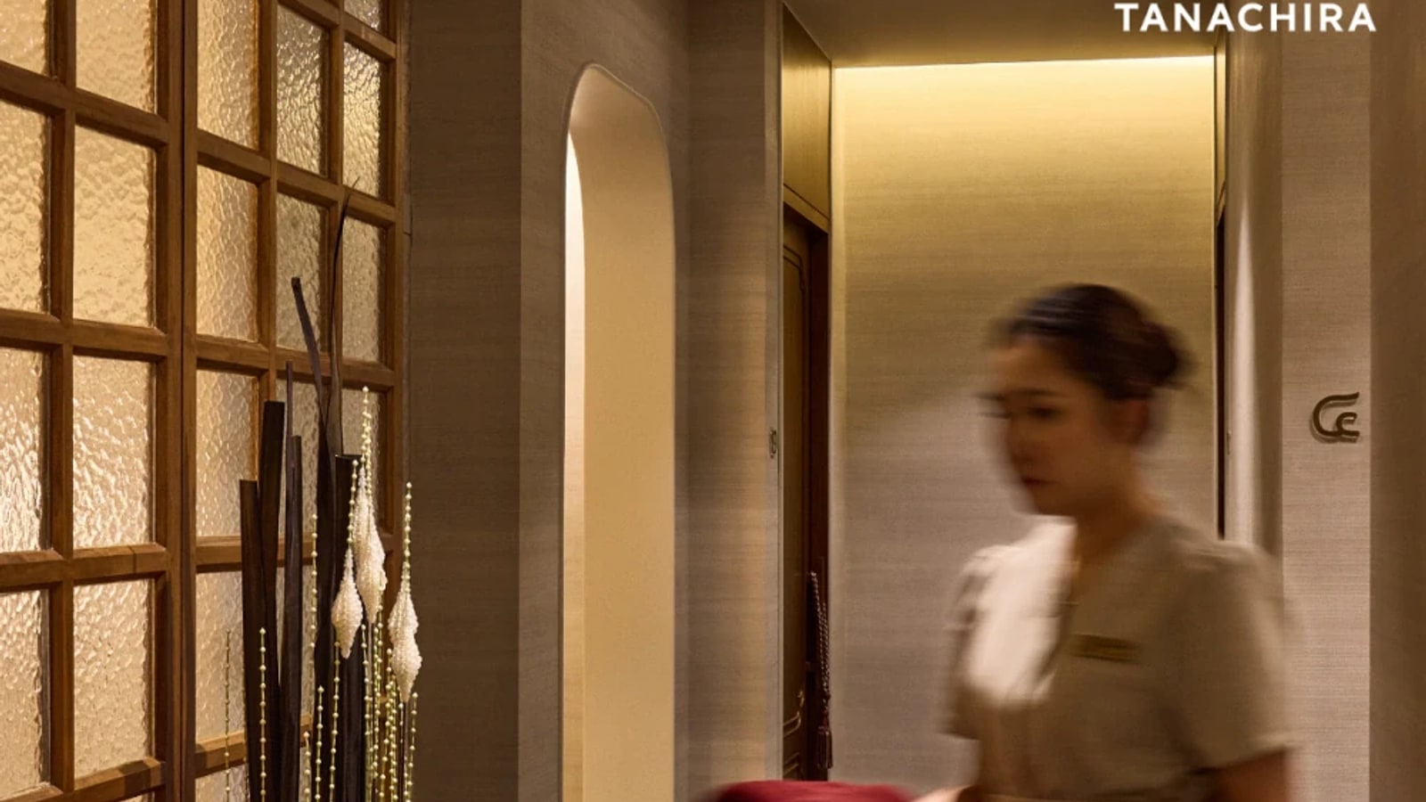 Therapist walking through HARNN Heritage Spa Surawong