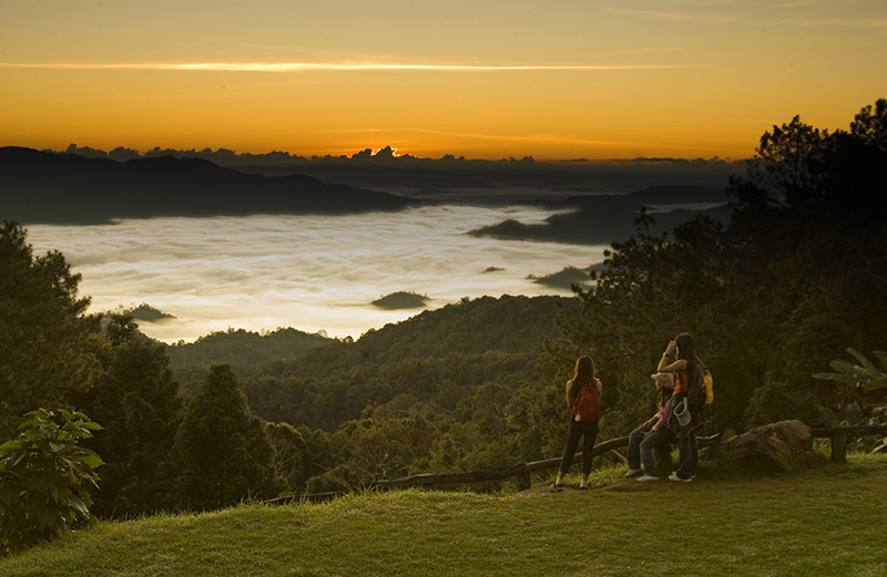 Golden sunrise above misty mountains at Huai Nam Dang National Park