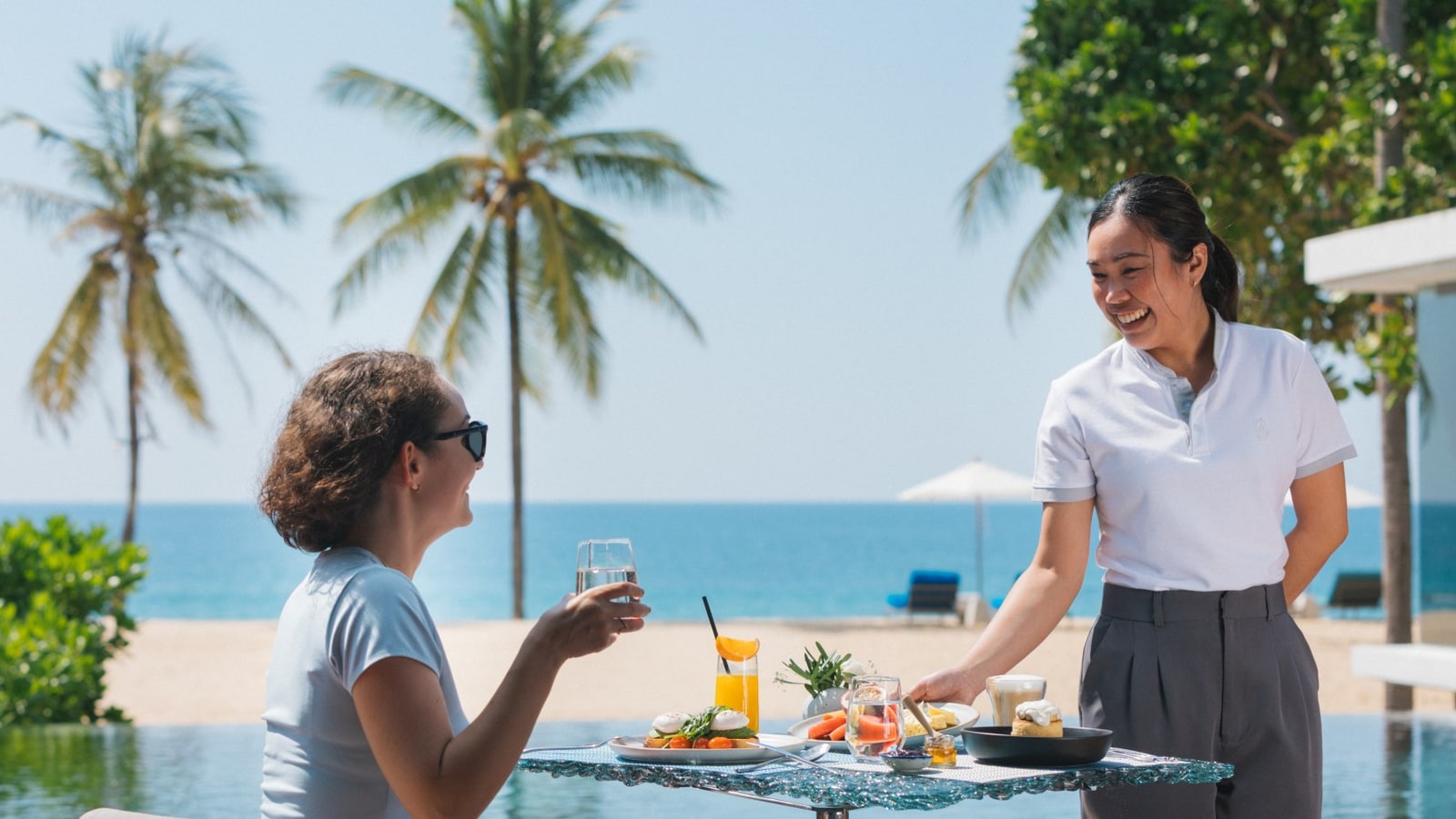 Guest dining beside the beach at Iniala Beach House