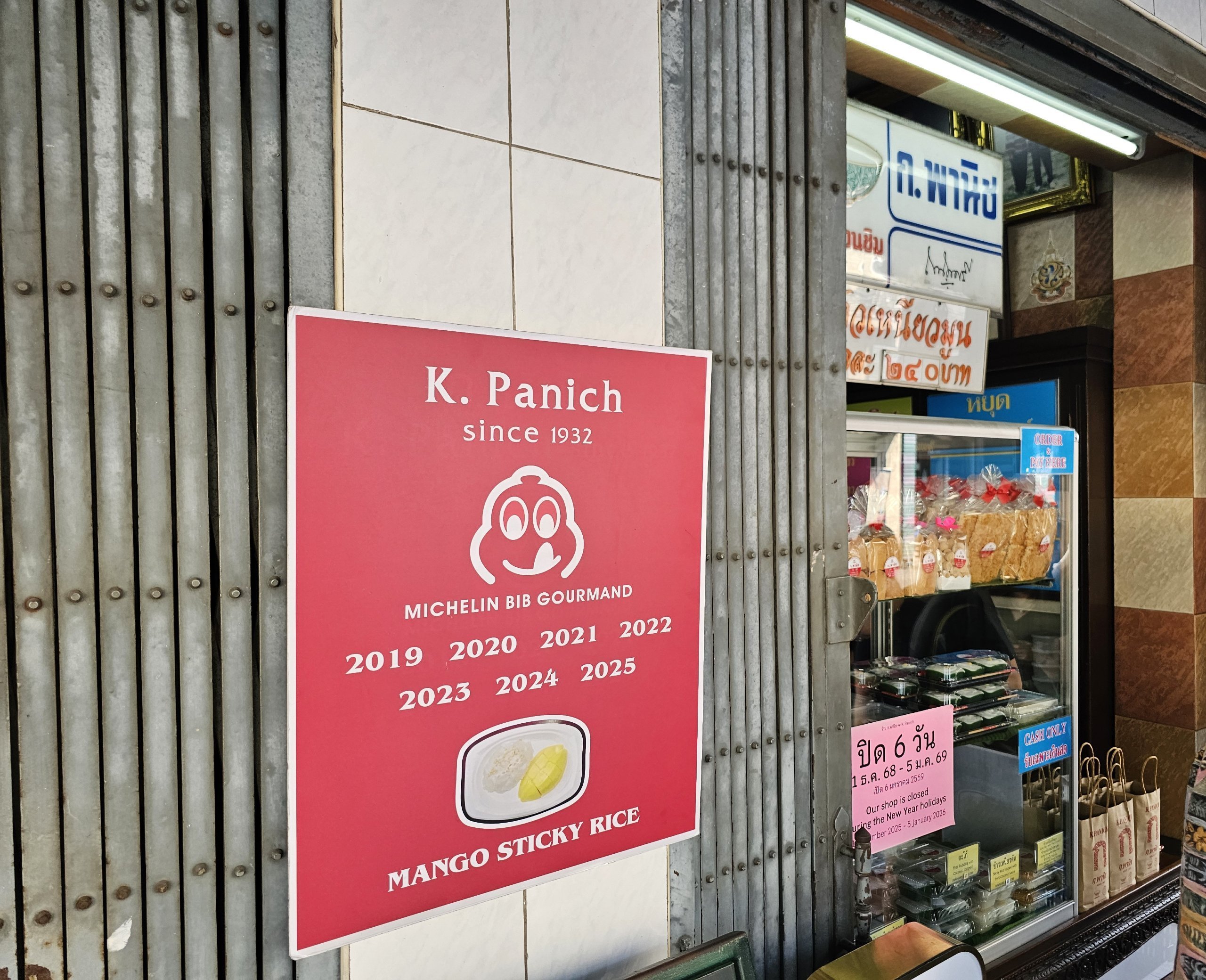 K Panich storefront and Michelin recognition sign