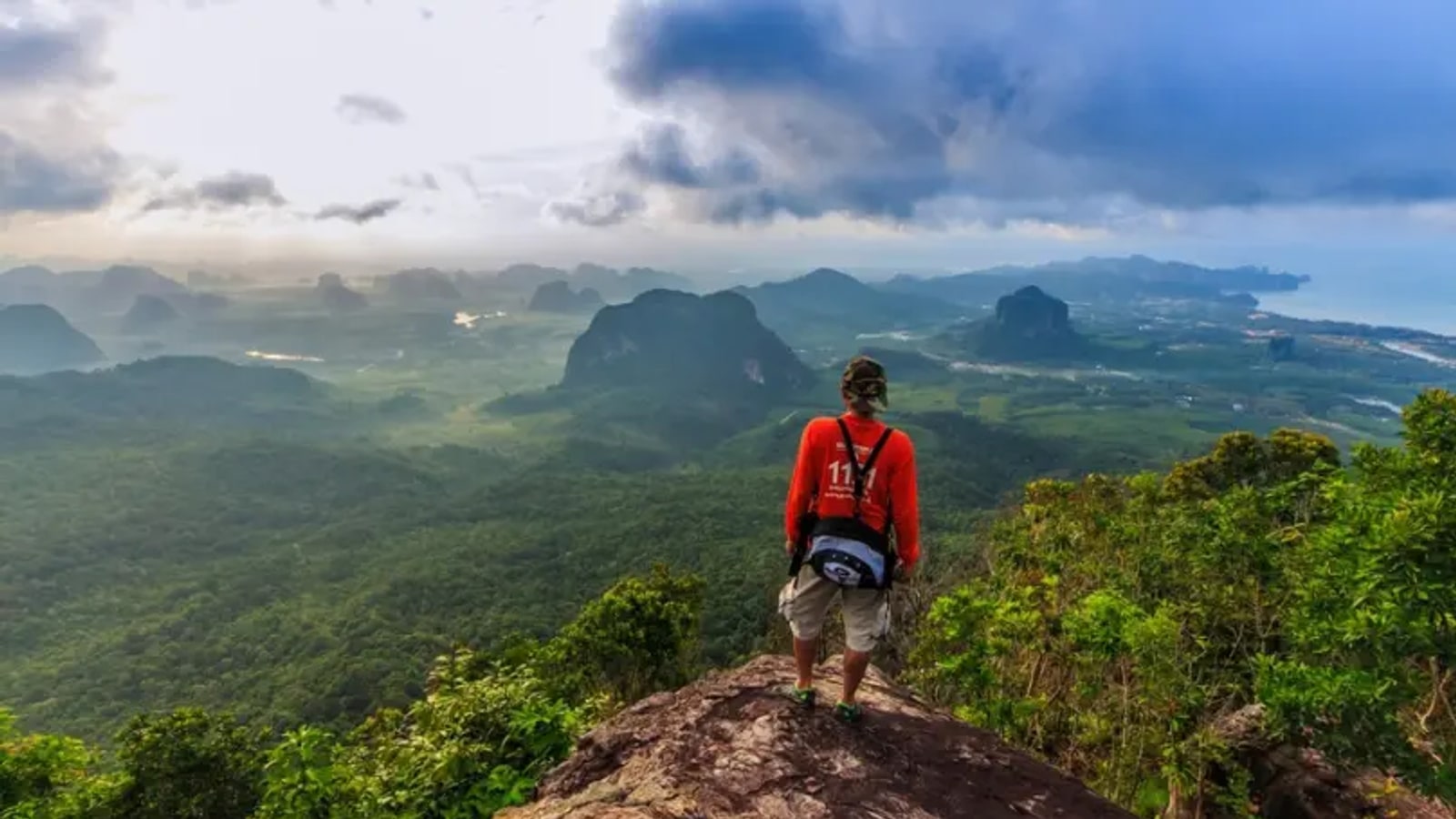 Hiker overlooking the landscape from Khao Ngon Nak