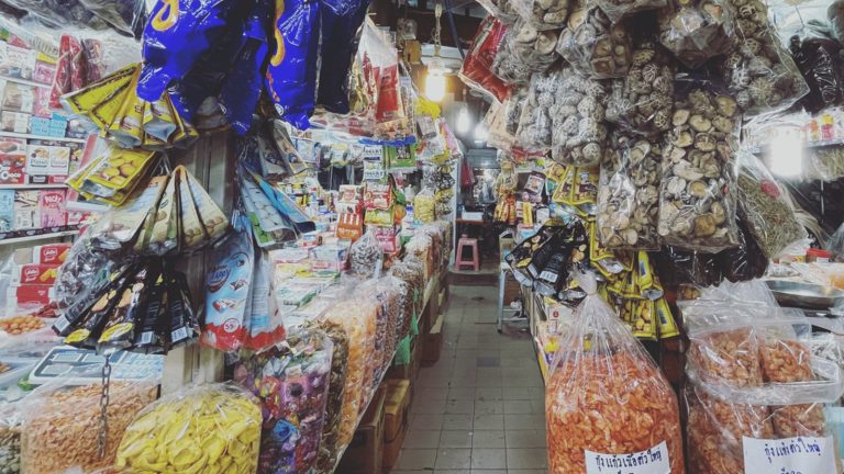 Dense display of dried foods and packaged snacks inside Kim Yong Market