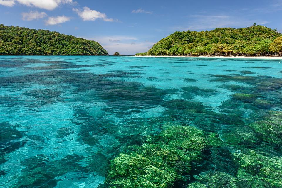 Shallow reef visible through clear water at Koh Rok