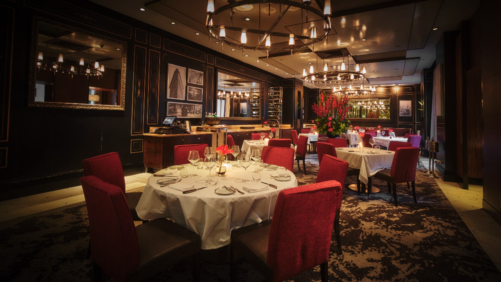Dining tables and red seating inside Madison Steak Avenue