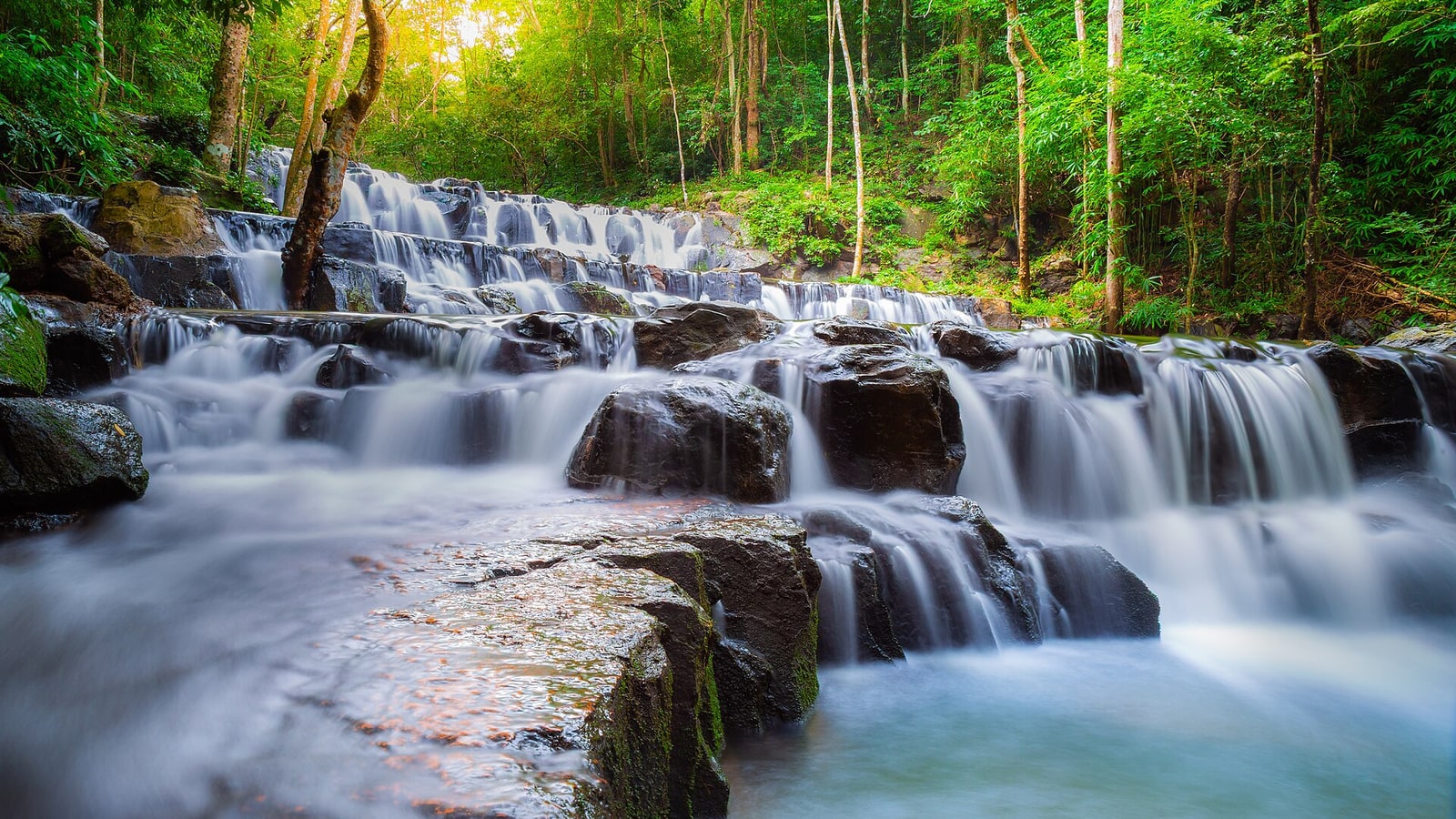 Water flowing over the stepped rock of Sam Lan Waterfall in Saraburi