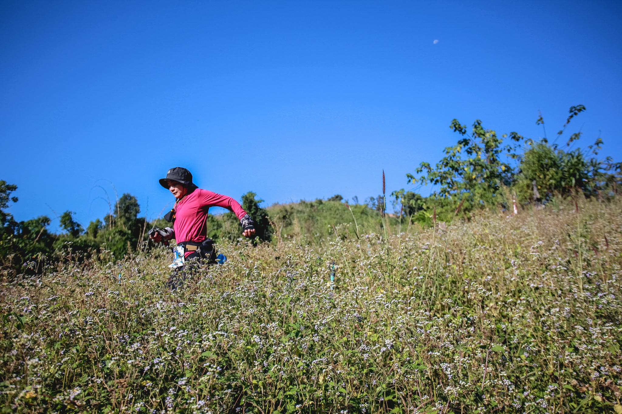 Runner moving through an open mountain section in Nan