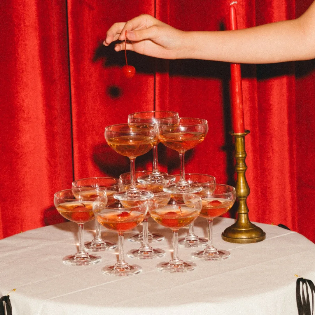 Cocktails arranged against the red curtains at Red Door Bangkok